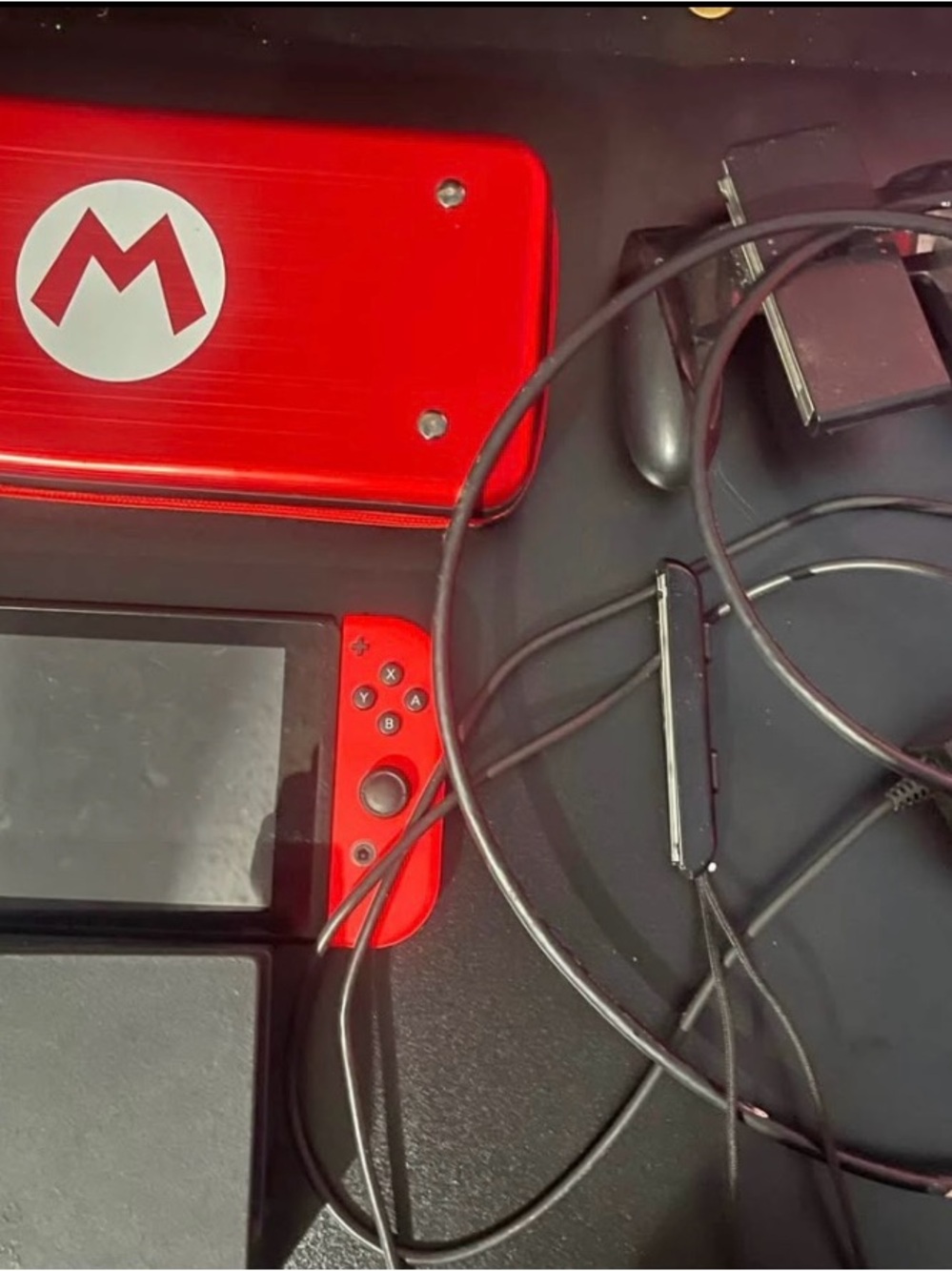 Nintendo Switch with Red Joy-Con and Red Mario Case